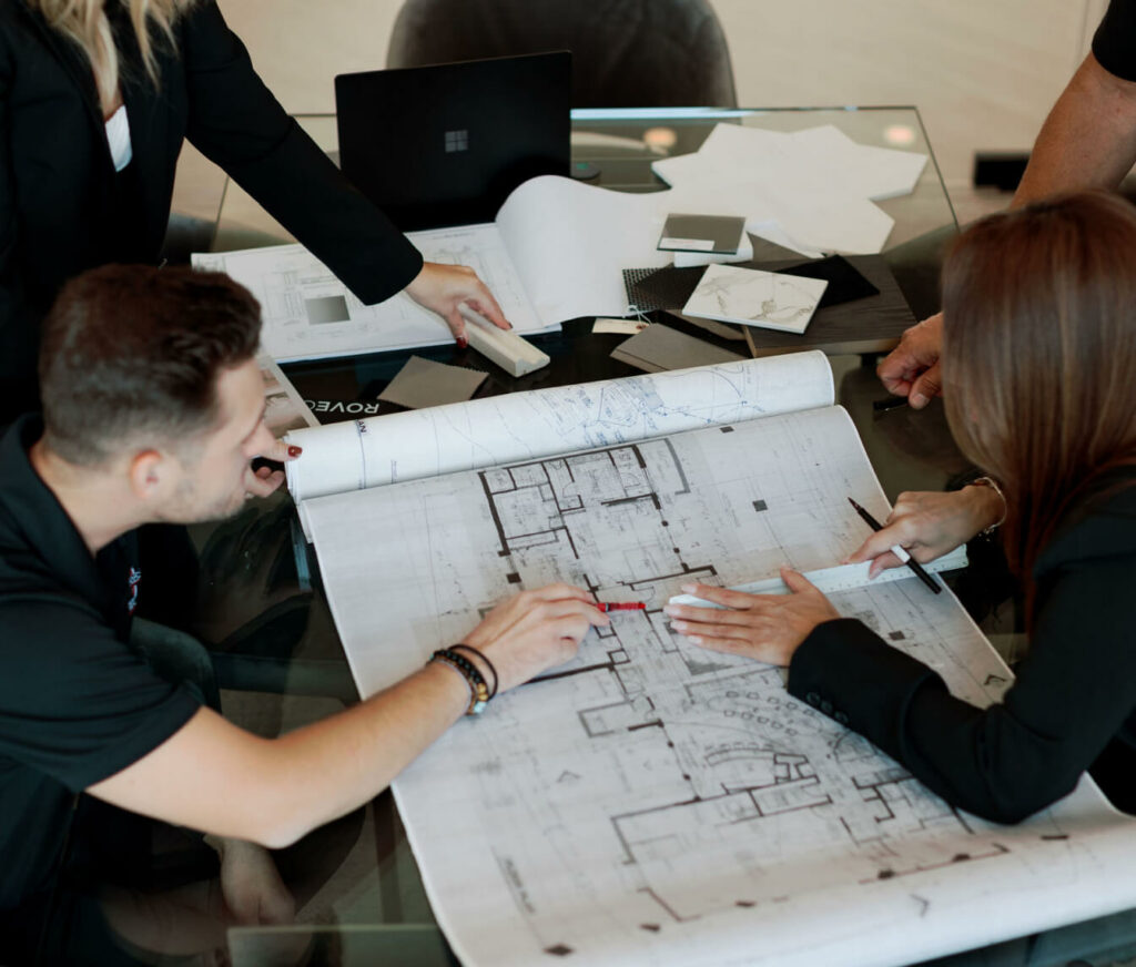 Woodcrest Design team reviewing blueprints and material samples for a luxury design-build project in Scottsdale.