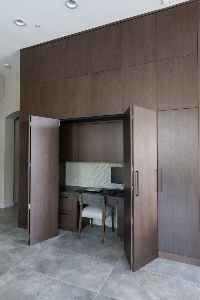 Luxurious home office nook with dark wood cabinetry and integrated desk, perfect for custom cabinetry designs by Woodcrest Design.